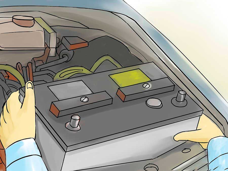 Механик извлекает аккумулятор из автомобиля
